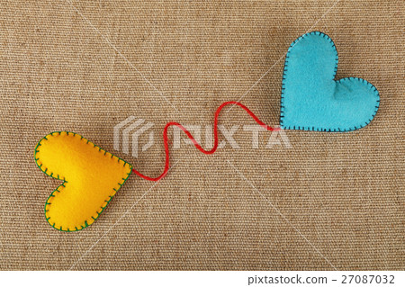 Two felt craft hearts, yellow and blue on canvas Two felt craft hearts, yellow and blue on canvas 27087032
