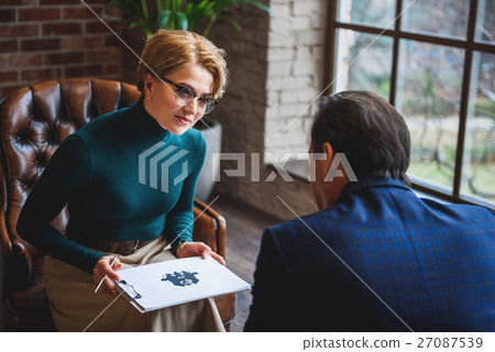 Attentive woman holding rorschach inkblot 27087539