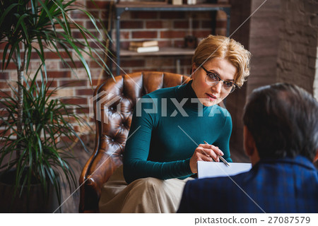 Concentrated female psychologist watching results Concentrated female psychologist watching results 27087579