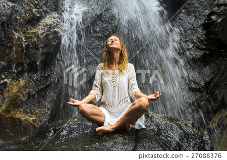 Female Practising Yoga on Waterfall. Stock image. 27088376