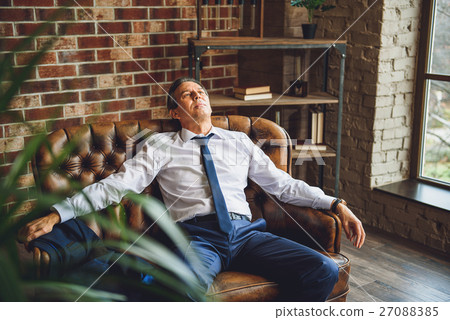 Tired man having some rest Tired man having some rest 27088385