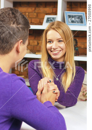 Beautiful girl looks at the boy and holding his Beautiful girl looks at the boy and holding his 27088998