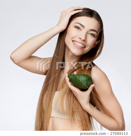 Beautiful Woman with Clean Fresh Skin holding 27089113