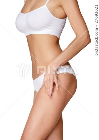 Torso of woman in white bikini sunbathing 27093021