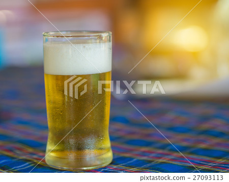 Cold beer in a glass, on Dining table . Cold beer in a glass, on Dining table . 27093113