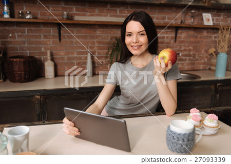 Positive delighted brunette posing at camera 27093339