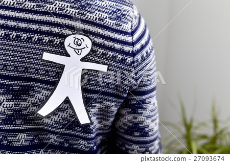 young man with a paper man attached to his back 27093674