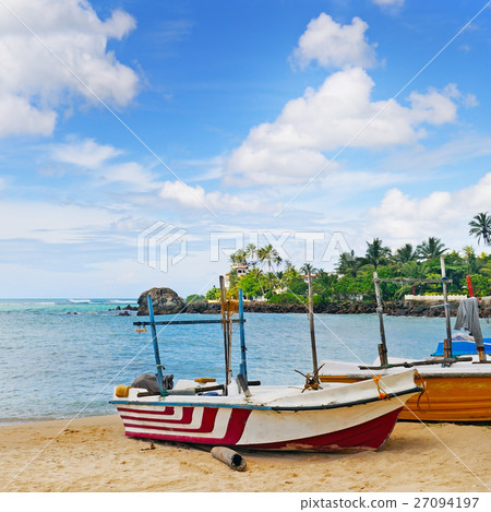 fishing boat on the sandy shore and ocean  27094197