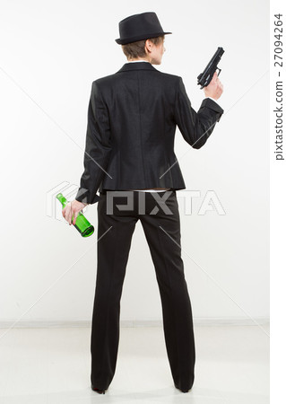 girl gangster holding a gun. Classic suit and hat. 27094264