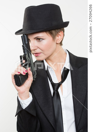 girl gangster holding a gun. Classic suit and hat. girl gangster holding a gun. Classic suit and hat. 27094266