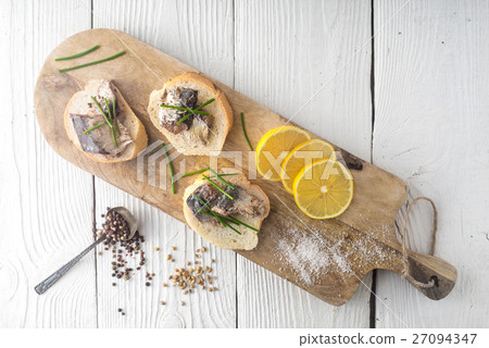 Sandwiches with sardines on a cutting board Sandwiches with sardines on a cutting board 27094347