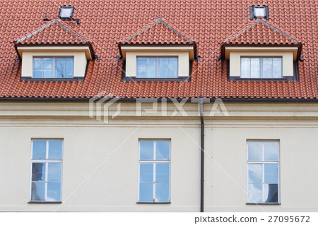 Typical building in Prague with a red roof closeup 27095672