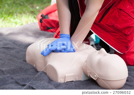 Paramedic demonstrate CPR on dummy Paramedic demonstrate CPR on dummy 27096032
