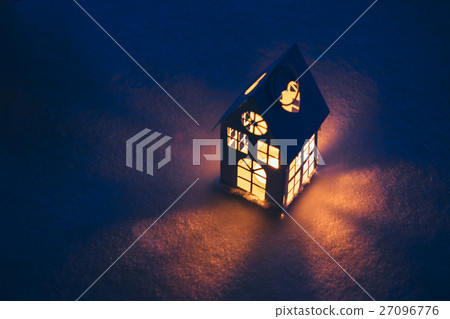 Lantern house with burning candle on snow in the 27096776
