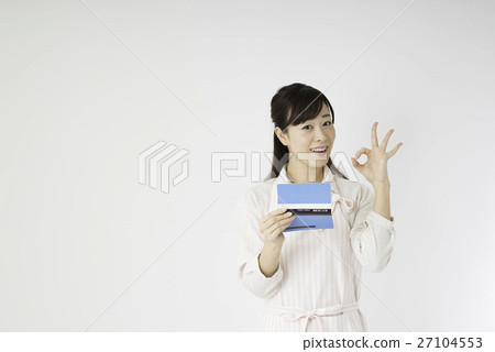 A woman looking at a passbook 27104553