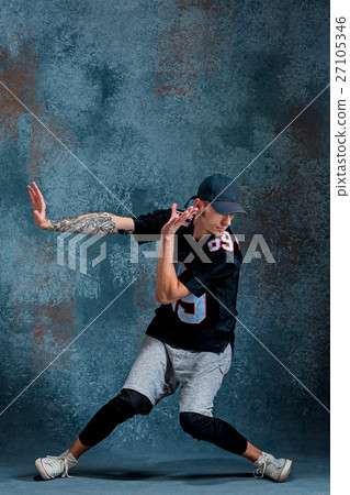 Young man break dancing on wall background. 27105346