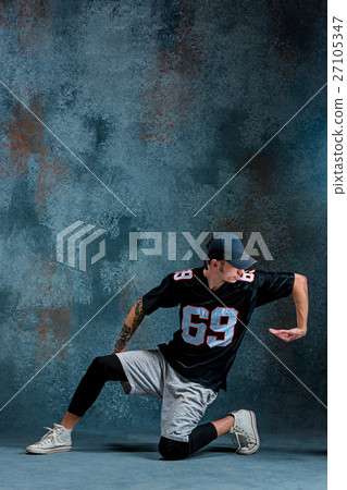 Young man break dancing on wall background. 27105347