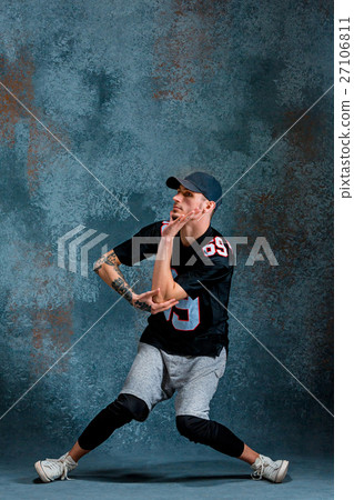 Young man break dancing on wall background. Young man break dancing on wall background. 27106811