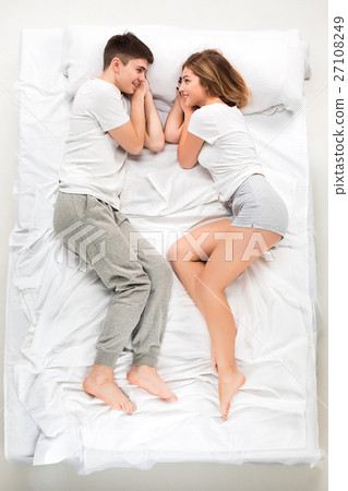 The young lovely couple lying in a bed 27108249