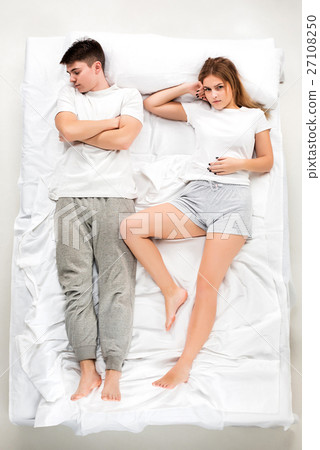 The young lovely couple lying in a bed The young lovely couple lying in a bed 27108250