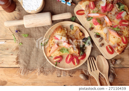 Italian pizza is delicious on wood background. 27110439