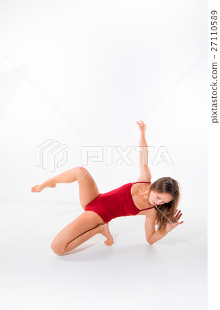 Young beautiful dancer in beige dress dancing on 27110589
