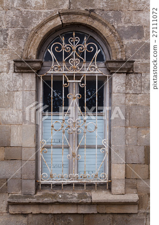 Window in old building with rusty lattice. 27111072