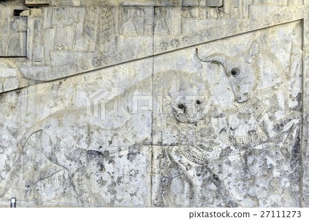 Famous bas relief carving of a lion hunting a bull 27111273