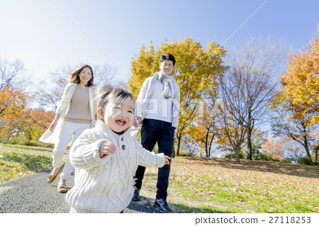 Three-person family playing in autumn park 27118253