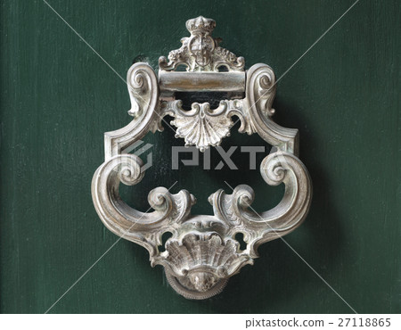 An antique knob on a vintage wooden green door An antique knob on a vintage wooden green door 27118865