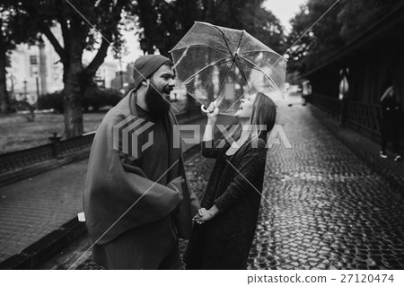 guy and girl under an umbrella 27120474