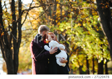 young family and newborn son in autumn park young family and newborn son in autumn park 27120478