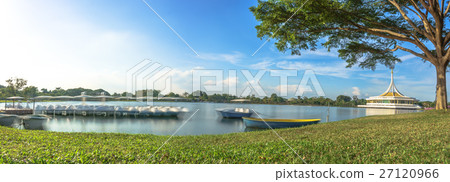 The tranquil lake with a boat in the foreground. The tranquil lake with a boat in the foreground. 27120966