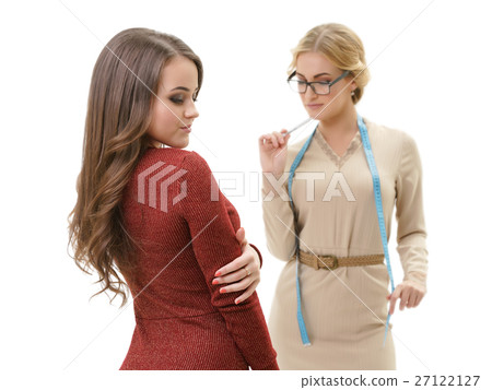 Young sexy dressmaker with her client studio shot Young sexy dressmaker with her client studio shot 27122127