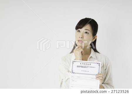 A woman looking at insurance policy 27123526