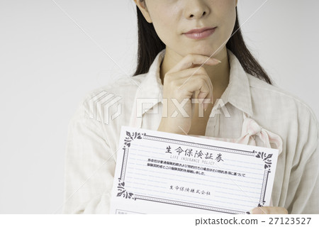 A woman looking at insurance policy 27123527