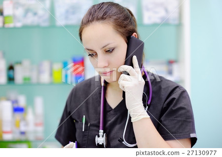 Female surgeon using cell phone 27130977