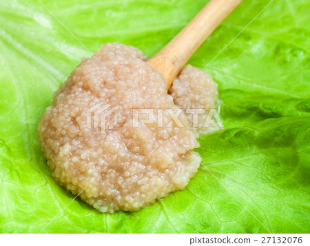 herring caviar in wood spoon on green lettuce 27132076