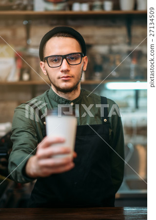 Barman in black apron stretches plastic cup 27134509