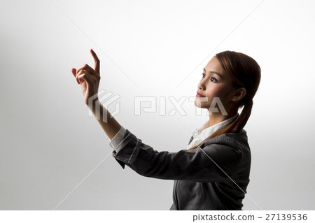 A woman pointing to space A woman pointing to space 27139536