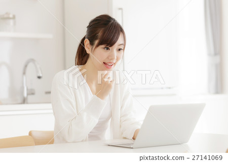 A woman using a computer A woman using a computer 27141069