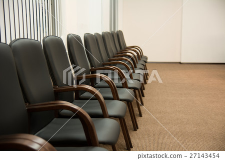 Leather black chairs are standing near the wall Leather black chairs are standing near the wall 27143454