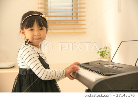 A girl playing piano 27145176
