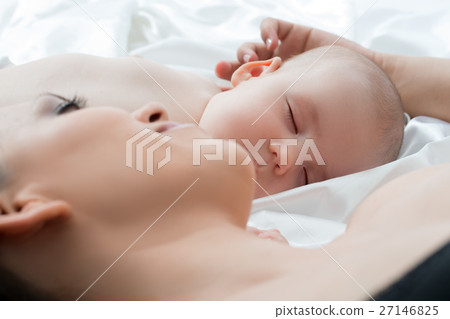 Baby boy sleeping and his mom lying on white linen Baby boy sleeping and his mom lying on white linen 27146825