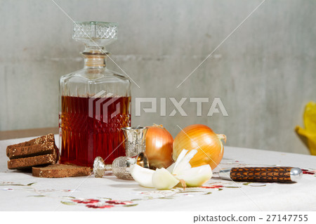 Carafe with alcohol tincture with snack stands on  Carafe with alcohol tincture with snack stands on  27147755