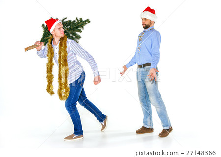 The young man in Santa cap carrying Christmas tree 27148366