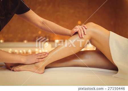 Professional masseuse massaging foot of girl 27150446