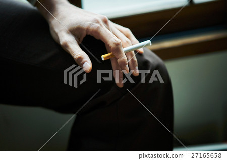 Smoking: Hand holding a cigarette 27165658