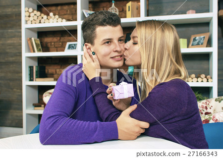 Young girl kisses her boyfriend for the gift Young girl kisses her boyfriend for the gift 27166343