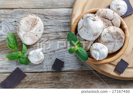 Delicate meringue in bowl,mint and dark chocolate. 27167480